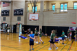 Kids playing games inside a school gym