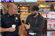 Officer at Coffee with Cops being interviewed